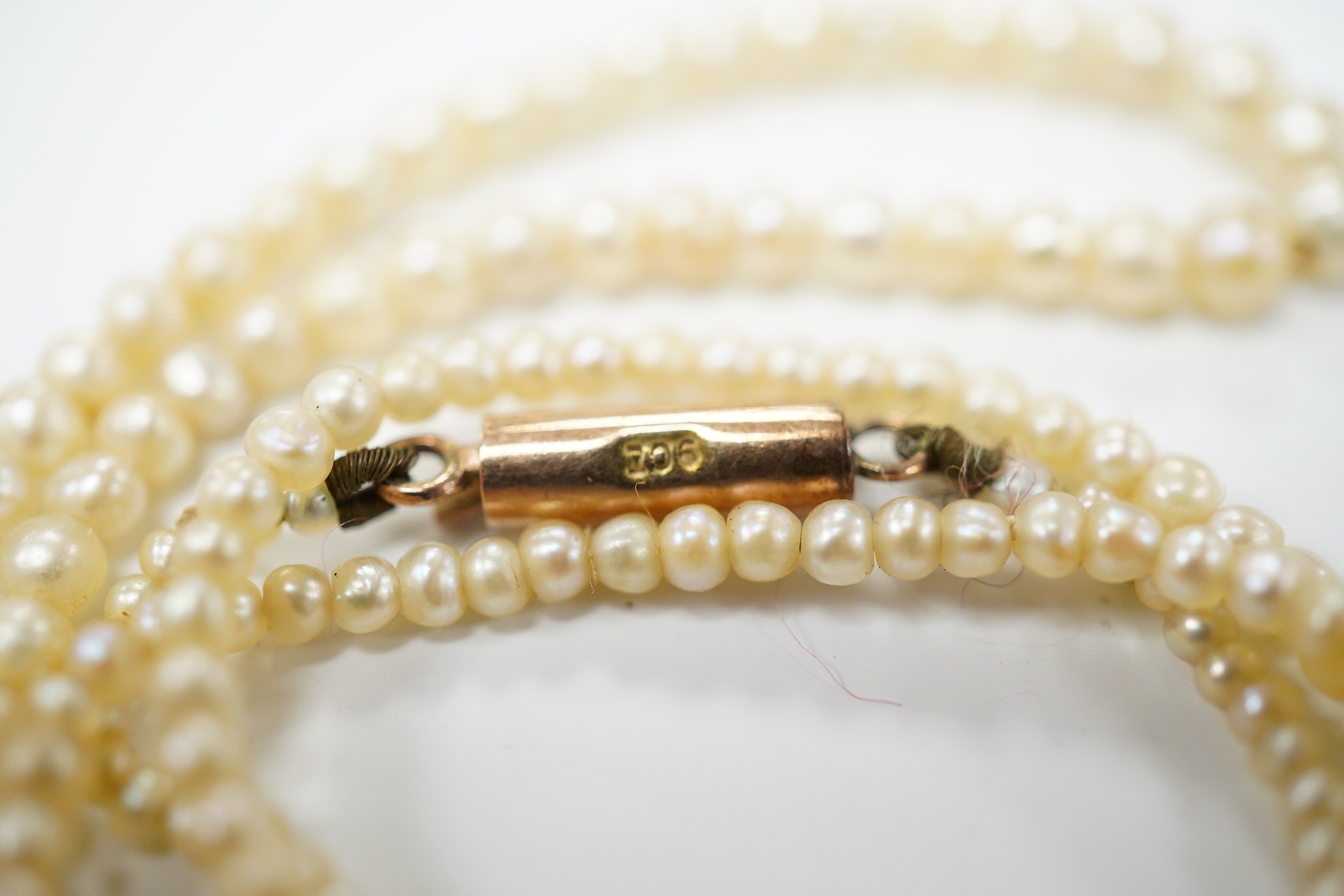 An early 20th century single strand graduated seed pearl necklace, with 9ct barrel clasp, 38cm. Condition - fair